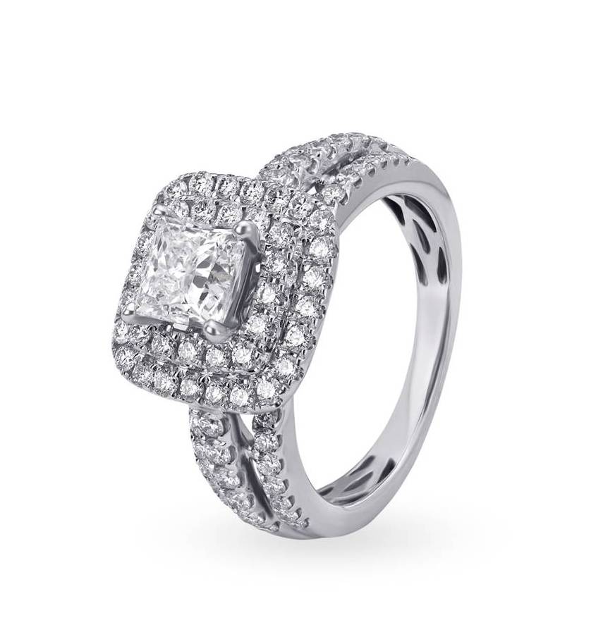 The solitaire ring framed with round diamonds is further bedecked with rows of diamonds partially covering its shanks.
